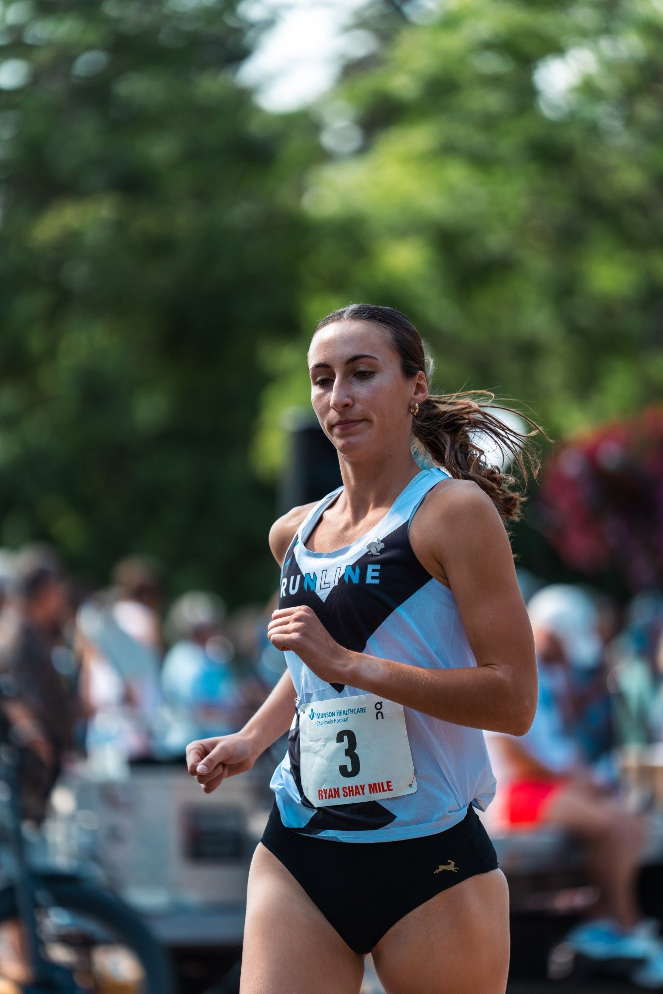 A Runline athlete racing a road mile in the Runline singlet